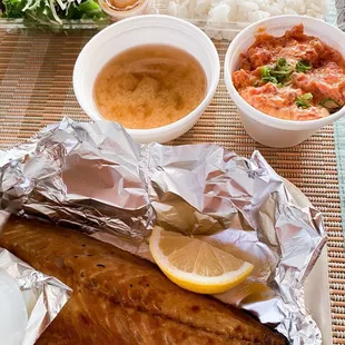 fish wrapped in foil with a side of rice