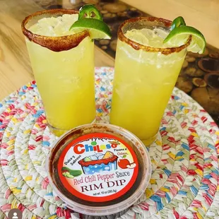 two margarita cocktails with lime garnish