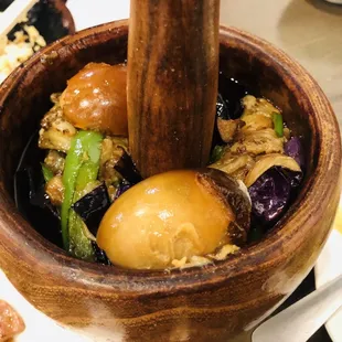 a wooden bowl of food on a table