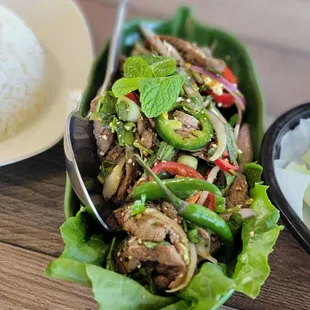 a plate of rice, meat and vegetables