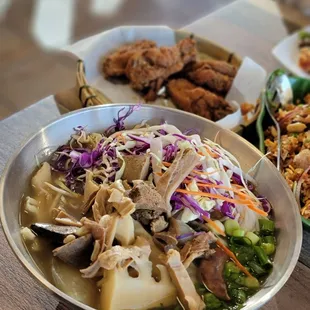 a bowl of soup and a plate of fried chicken