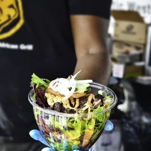 a man holding a salad