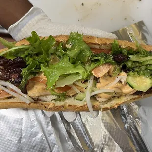 a hand holding a sandwich