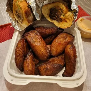 Beef kabob sandwich with fried plantains, side sauce