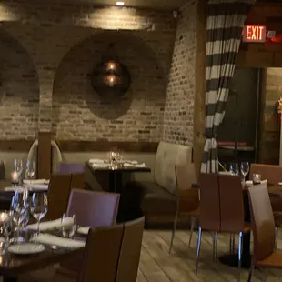 a restaurant with a brick wall