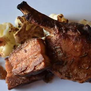 Duo of pork: Artisanal pork chop &amp; crisped pork belly ~ star anise-roasted cauliflower ~  warm spiced grape jam