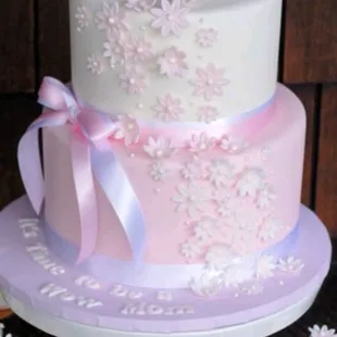 a three tiered cake and cupcakes