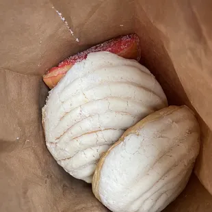 White concha and some bow shaped bread.