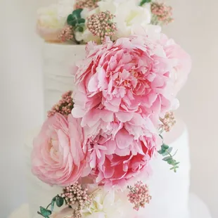 a wedding cake with pink and white flowers