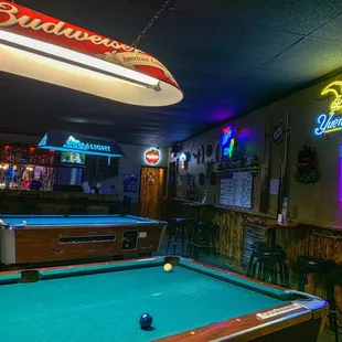 pool table and neon signs