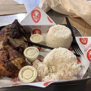 a tray of food with rice and chicken