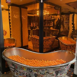 a bathtub filled with oranges