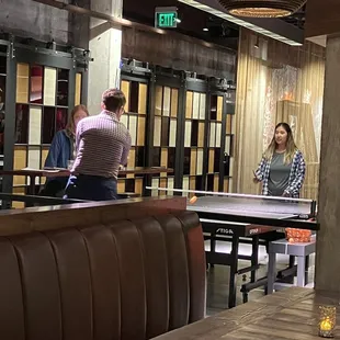 a man and a woman playing ping pong