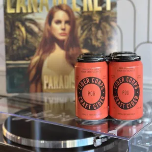 two cans of beer on a turntable
