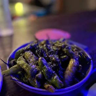 a bowl of green beans on a table