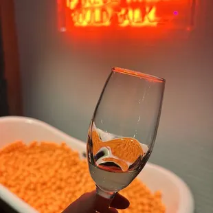 a hand holding a glass of wine