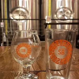 two beer glasses on a wooden table