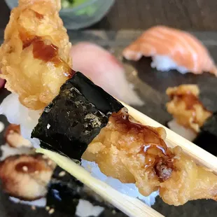 sushi being held by chopsticks