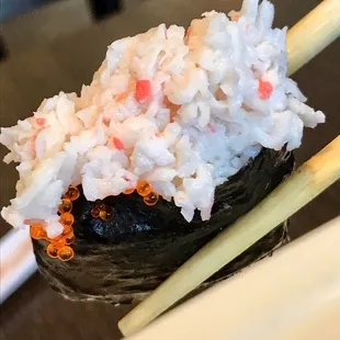 a sushi with rice and chopsticks
