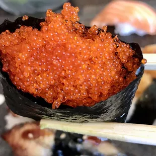 a sushi roll with red cavia