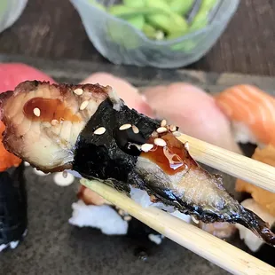 sushi being held by chopsticks