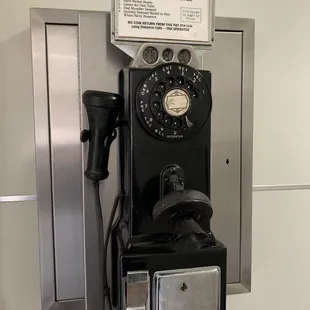 a payphone with a sign on it