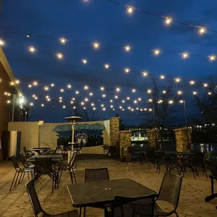 a patio with tables and chairs