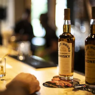 two bottles of whiskey on a bar