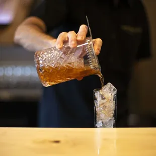 a bartender pouring a drink