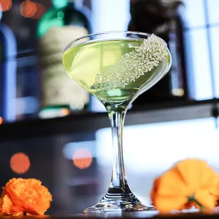 a green cocktail in a martini glass