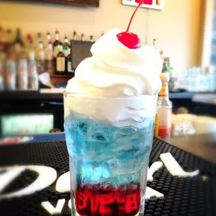 a drink with a cherry on top