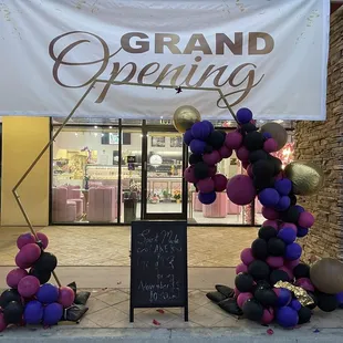 grand opening sign and balloons