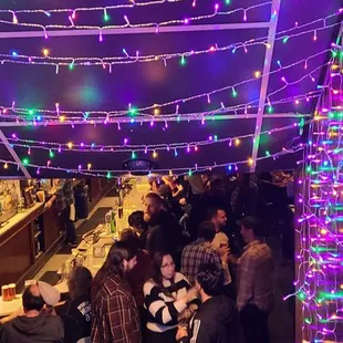 a large group of people sitting at a bar