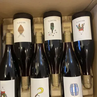 six bottles of wine in a cardboard box
