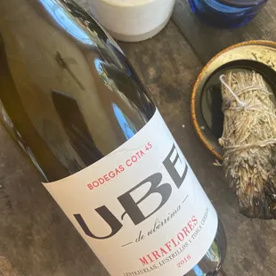 a bottle of white wine on a wooden table