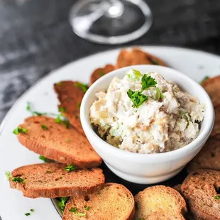a plate of crackers and a bowl of dip