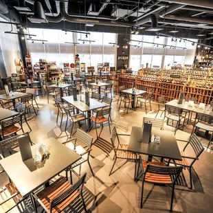 the interior of a restaurant with tables and chairs