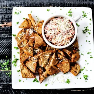 a plate of food with a bowl of dip