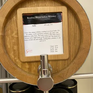 a wooden barrel with a sign on it