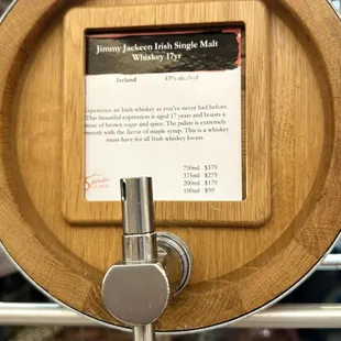 a wooden barrel with a sign on it