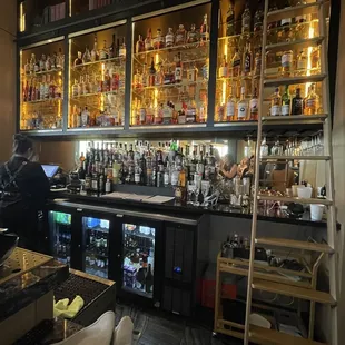 a bar with shelves full of liquor bottles