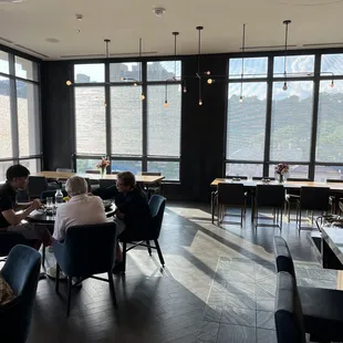 a group of people sitting at tables in a restaurant
