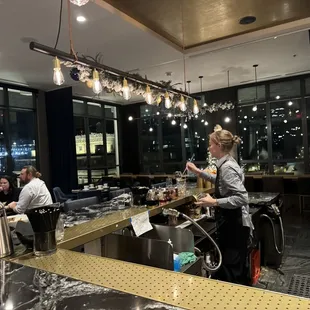 a bartender pouring a drink at a bar