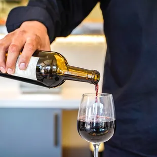 a man pouring wine into a glass