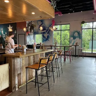 a bar with stools and tables