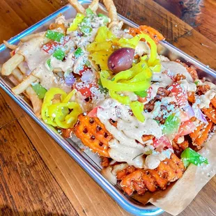 a tray of fries and vegetables