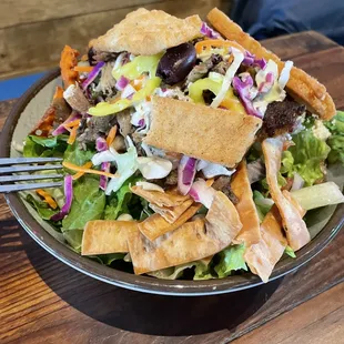 a plate of salad with a fork