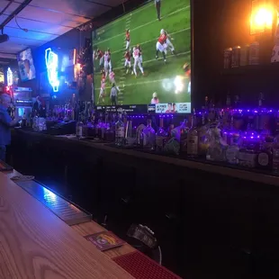 a bar with a large television