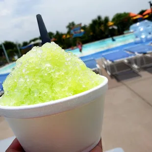 One of their delicious snow cones in front of the lazy river which has plenty of tubes