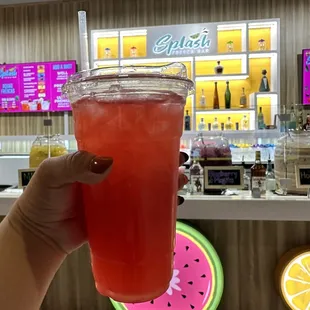 a person holding a drink